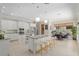 Bright kitchen with white cabinets, granite countertops, stainless appliances, pendant lights, breakfast bar and open floor plan at 2010 Se 25Th St, Ocala, FL 34471