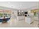 Bright kitchen with white cabinets, granite countertops, stainless appliances, pendant lights, breakfast nook and open floor plan at 2010 Se 25Th St, Ocala, FL 34471