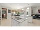Bright kitchen with white cabinets, granite countertops, breakfast nook, kitchen island and open floor plan at 2010 Se 25Th St, Ocala, FL 34471