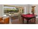 Screened lanai featuring a pool table, lounge area with outdoor seating, and a view of the pool at 2010 Se 25Th St, Ocala, FL 34471