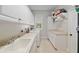 Bright laundry room with white cabinets, sink, washer, dryer, and lots of storage at 2010 Se 25Th St, Ocala, FL 34471