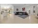 Open concept living room featuring sectional seating, access to the kitchen, and adjacent room at 2010 Se 25Th St, Ocala, FL 34471