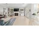 Open living room features a fireplace, built in shelving and bar seating at the kitchen counter at 2010 Se 25Th St, Ocala, FL 34471