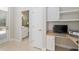 Functional home office with built-in desk, cabinets, and easy access to an adjacent bathroom at 2010 Se 25Th St, Ocala, FL 34471
