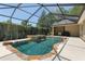 Screened in pool with stone water feature and view of backyard at 2010 Se 25Th St, Ocala, FL 34471