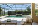 Covered pool area with a stone waterfall feature and patio seating at 2010 Se 25Th St, Ocala, FL 34471