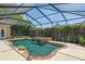 Screened pool with stone waterfall feature and partially covered patio at 2010 Se 25Th St, Ocala, FL 34471