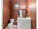 Stylish powder room with a white vanity and decorative mirror at 2010 Se 25Th St, Ocala, FL 34471