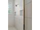 Modern shower features white subway tile, a glass block window, and built-in shelving at 2010 Se 25Th St, Ocala, FL 34471