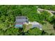 Aerial view of property featuring a pool, detached garage, lush trees and large yard at 20861 Sw 81St Loop, Dunnellon, FL 34431
