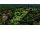 Stunning aerial view showcasing a lush green property surrounded by mature trees and a nearby golf course at 20861 Sw 81St Loop, Dunnellon, FL 34431