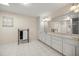 Bright bathroom showcasing tiled floor, large vanity, mirrors, and modern light fixtures at 20861 Sw 81St Loop, Dunnellon, FL 34431