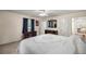 Bright bedroom featuring a ceiling fan, desk, and a comfortable bed with white patterned comforter at 20861 Sw 81St Loop, Dunnellon, FL 34431