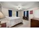 Comfortable bedroom featuring a ceiling fan, windows with shutters, and a cozy atmosphere at 20861 Sw 81St Loop, Dunnellon, FL 34431