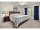 Cozy bedroom with a large bed, bedside table, and window with curtains, creating a relaxing space at 20861 Sw 81St Loop, Dunnellon, FL 34431