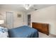 This bedroom features neutral walls, closet, ceiling fan and a large dresser at 20861 Sw 81St Loop, Dunnellon, FL 34431