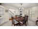 Elegant dining room with a large wooden table, seating for eight, and bright natural light from shuttered windows at 20861 Sw 81St Loop, Dunnellon, FL 34431