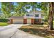 Two story home with brick facade, an attached two car garage, and a balcony on the second story at 20861 Sw 81St Loop, Dunnellon, FL 34431