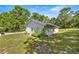 Detached building surrounded by well manicured lawn and landscaping on a sunny day at 20861 Sw 81St Loop, Dunnellon, FL 34431