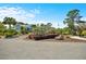 Attractive blue building with a circular driveway surrounded by manicured landscaping and a clear blue sky at 20861 Sw 81St Loop, Dunnellon, FL 34431