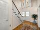 Welcoming foyer featuring a staircase, hardwood floors, and natural light from the double-door entry at 20861 Sw 81St Loop, Dunnellon, FL 34431