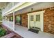 Welcoming front porch with brick accents, white trim, double doors, and elegant details at 20861 Sw 81St Loop, Dunnellon, FL 34431