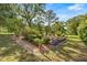 A lush fenced garden is set in a scenic yard with mature trees and landscaping at 20861 Sw 81St Loop, Dunnellon, FL 34431