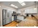 Modern kitchen with stainless steel appliances, granite countertops, white cabinets, and hardwood floors at 20861 Sw 81St Loop, Dunnellon, FL 34431