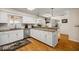 Bright kitchen featuring white cabinets, granite countertops, stainless steel appliances, and hardwood floors at 20861 Sw 81St Loop, Dunnellon, FL 34431