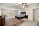 Spacious main bedroom suite featuring carpeted floors, ceiling fans, and a large area rug at 20861 Sw 81St Loop, Dunnellon, FL 34431