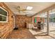 Outdoor kitchen with brick floors and brick walls with a built in grill and ceiling fan at 20861 Sw 81St Loop, Dunnellon, FL 34431
