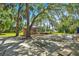 Outdoor area with tables, seating, and a stage surrounded by lush trees and partial shade at 20861 Sw 81St Loop, Dunnellon, FL 34431