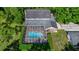 Aerial shot showcasing a screened pool and landscaped backyard at 20861 Sw 81St Loop, Dunnellon, FL 34431