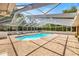 Screened-in pool with an attached spa, brick flooring and lounge chairs to relax in the sun at 20861 Sw 81St Loop, Dunnellon, FL 34431
