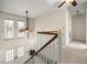 Bright second floor landing with a staircase, hardwood railing and double-door entryway below at 20861 Sw 81St Loop, Dunnellon, FL 34431