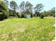 Large backyard with storage shed and fencing surrounded by mature shade trees at 21298 Sw Peach Blossom St, Dunnellon, FL 34431