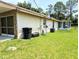 The backyard features a well-manicured lawn and a partially screened-in porch at 21298 Sw Peach Blossom St, Dunnellon, FL 34431