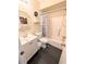 Traditional bathroom with a white vanity, octagonal mirror, toilet and shower-tub combination at 21298 Sw Peach Blossom St, Dunnellon, FL 34431