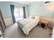 Bright bedroom with sliding door to outdoor screened porch at 21298 Sw Peach Blossom St, Dunnellon, FL 34431