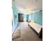 Bright bedroom with light blue walls and a large window; washer and dryer can be seen through the back window at 21298 Sw Peach Blossom St, Dunnellon, FL 34431