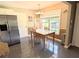 Cozy dining area adjacent to the kitchen with natural light from a bright window at 21298 Sw Peach Blossom St, Dunnellon, FL 34431