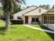 Inviting front entrance with seating, a well-manicured lawn, and charming curb appeal at 21298 Sw Peach Blossom St, Dunnellon, FL 34431