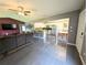 Spacious open-concept living area with tile floors, kitchen view, and stainless steel appliances at 21298 Sw Peach Blossom St, Dunnellon, FL 34431