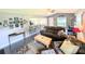 Cozy living room featuring a large sofa, ceiling fan, and an open view to the kitchen and dining area at 21298 Sw Peach Blossom St, Dunnellon, FL 34431