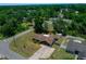 Aerial view of the property showcasing the home's location, landscaping, and surrounding neighborhood with mature trees at 23 Larch Crse, Ocala, FL 34480