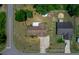 Aerial view of the property illustrating its layout, including the driveway, landscaping, and proximity to neighboring houses at 23 Larch Crse, Ocala, FL 34480