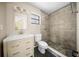 Updated bathroom featuring a stone shower, modern vanity, and neutral color palette at 23 Larch Crse, Ocala, FL 34480