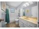 Well-lit bathroom featuring a tub with shower, vanity, and decorative starfish accents at 23 Larch Crse, Ocala, FL 34480