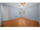 Bedroom featuring a ceiling fan, natural lighting, and hardwood floors at 23 Larch Crse, Ocala, FL 34480