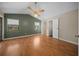 Spacious bedroom features wood floors, a ceiling fan, and windows providing natural light at 23 Larch Crse, Ocala, FL 34480